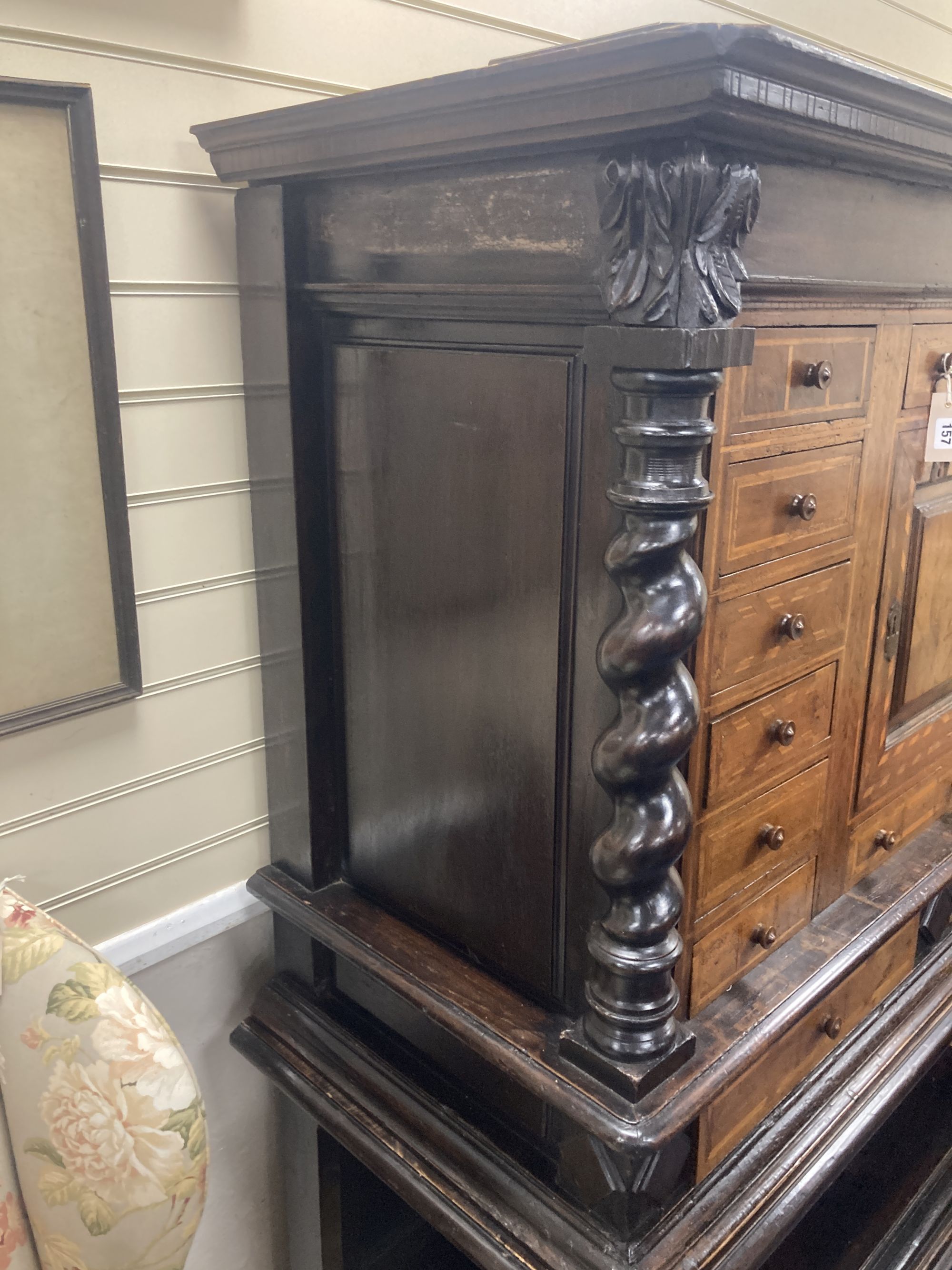 An early 19th century Dutch ebonised parquetry inlaid walnut cabinet on stand, width 136cm, depth 60cm, height 171cm